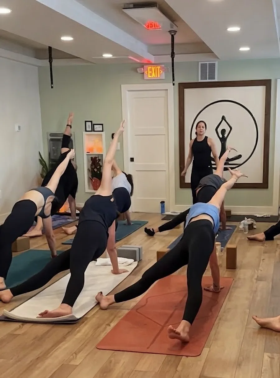 A full community class practicing together at Yoga in the Circle