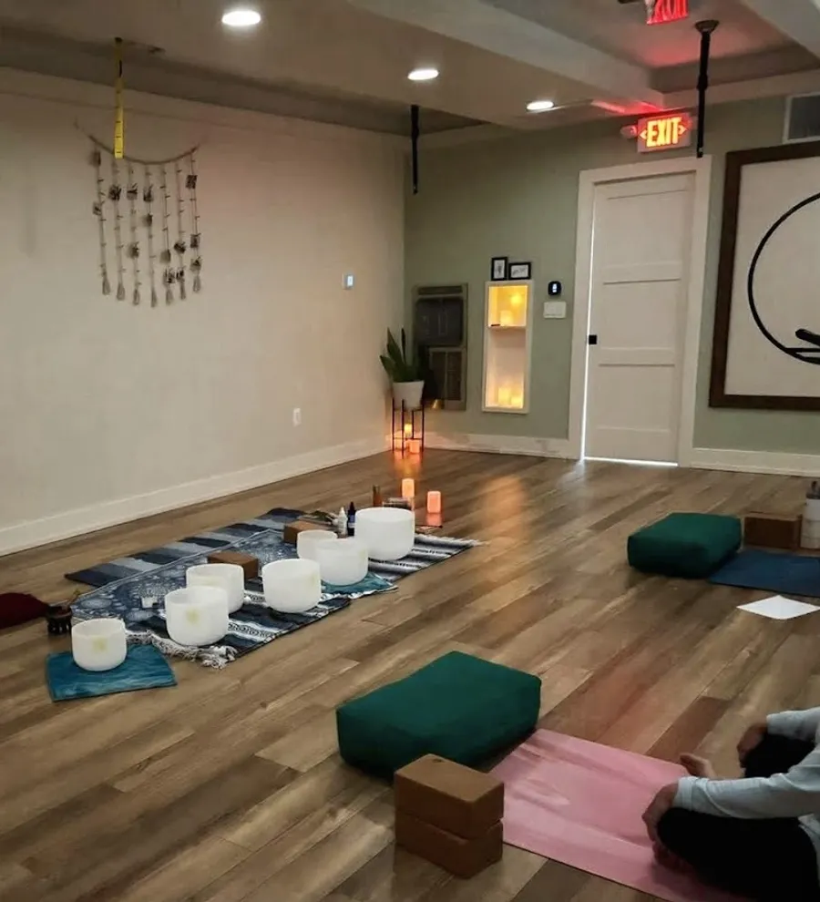 Candlelit healing space with crystal sound bowls at Yoga in the Circle